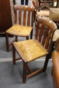 A set of six unusual walnut dining chairs with slatted backs and leather cloth upholstered seats.