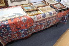 A Persian rug, rust ground with stylized decoration.
