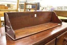An Edwardian mahogany book trough.