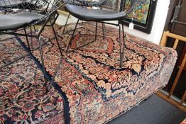 A Persian rug dark blue ground, with floral decoration.