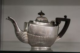 A small silver teapot.