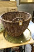 A wicker basket, eastern brass tray and a floor standing lamp.