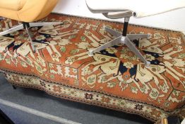 A rust ground Persian rug with large stylized motifs.