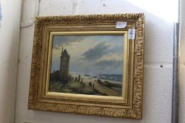 A small coastal landscape with figures and buildings, oil on board in a decorative gilt frame.