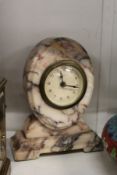 A small alabaster mantle clock.