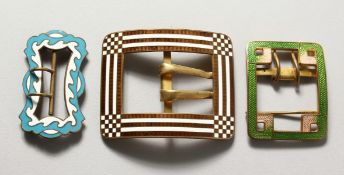Three large enamel buckles.