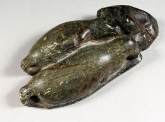 An Inuit carved hardstone of two seals.