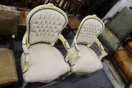 A pair of French style cream painted and upholstered open armchairs.