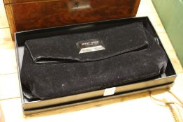 A Giorgio Armani black velvet evening bag, boxed.