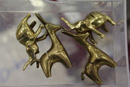 Four small bronze reindeer shaped place name holders.
