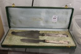 A continental silver handled cake slice and similar knife, boxed.