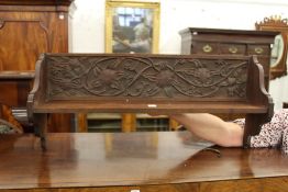 A carved walnut bookshelf.