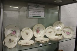 A quantity of Royal Copenhagen porcelain plates and serving dishes, cream ground with floral
