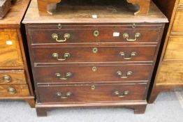 A George III mahogany bachelor's chest with brushing slide over four graduated long drawers, on