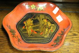A Chinese red lacquer lobed bowl decorated with figures to the centre.