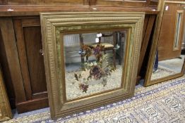 A Victorian gilt framed mirror with painted decoration.