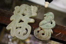 Two Chinese carved jade amulets.