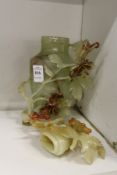 A Chinese carved jadeite vase and cover (some repairs and faults).
