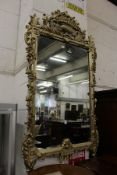 A large decorative silvered frame mirror.