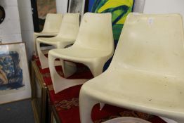 In the manner of Verner Panton, a set of four moulded plastic stacking chairs.