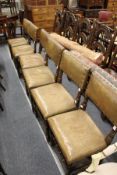 A set of six beech framed dining chairs with leather cloth upholstered backs and seats.