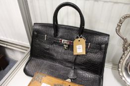 A good ladies' black leather handbag.