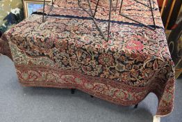 A Persian rug, early 20th century, dark blue ground with floral decoration.