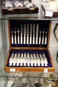 A cased set of eighteen mother-of-pearl handled fruit knives and forks (lacking one knife).