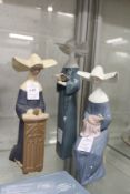 Three Lladro figures of nuns.