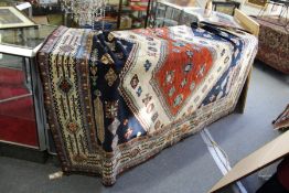 A large Persian carpet with three large rust ground lozenge shaped central motifs (some wear and