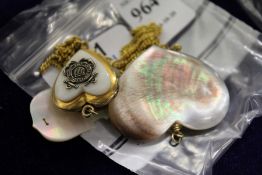 Three decorative pendants and chains.