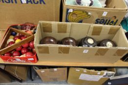 Four bowling woods and a quantity of snooker balls.