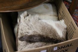A quantity of animal skin cushions.