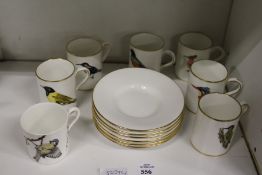 A set of six Hammersley china coffee cups and saucers decorated by Roland Ward with various birds,