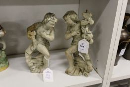 Two carved and painted wooden figures.