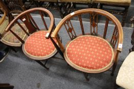 Two Edwardian mahogany horseshoe shaped occasional chairs.