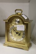 A Swiza brass mantle clock.
