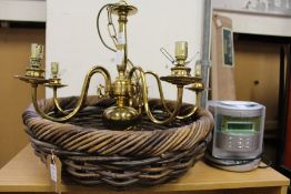 A wicker basket, a brass chandelier, a mini hi-fi.