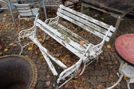 A pair of cast iron and wooden slatted garden benches (AF).