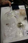 A quantity of unset gemstones and other items.