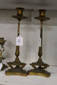 A good pair of ormolu candlesticks on concave sided bases.