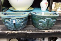 A pair of pottery wall planters.