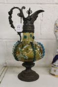 An ornate metal and glass claret jug (AF).