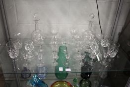 A pair of cut glass decanters and other glassware.