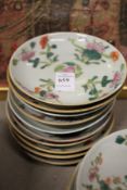 Ten small Chinese floral decorated saucers.