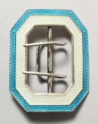 A silver and turquoise enamel buckle.