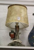 A table lamp, the base modelled as a kingfisher on a branch.