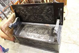 A carved oak monk's bench.