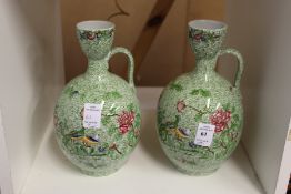 A pair of Copeland Spode floral decorated jugs (AF).