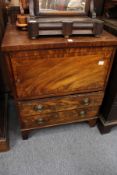 A 19th century mahogany commode with a single door and two drawers.